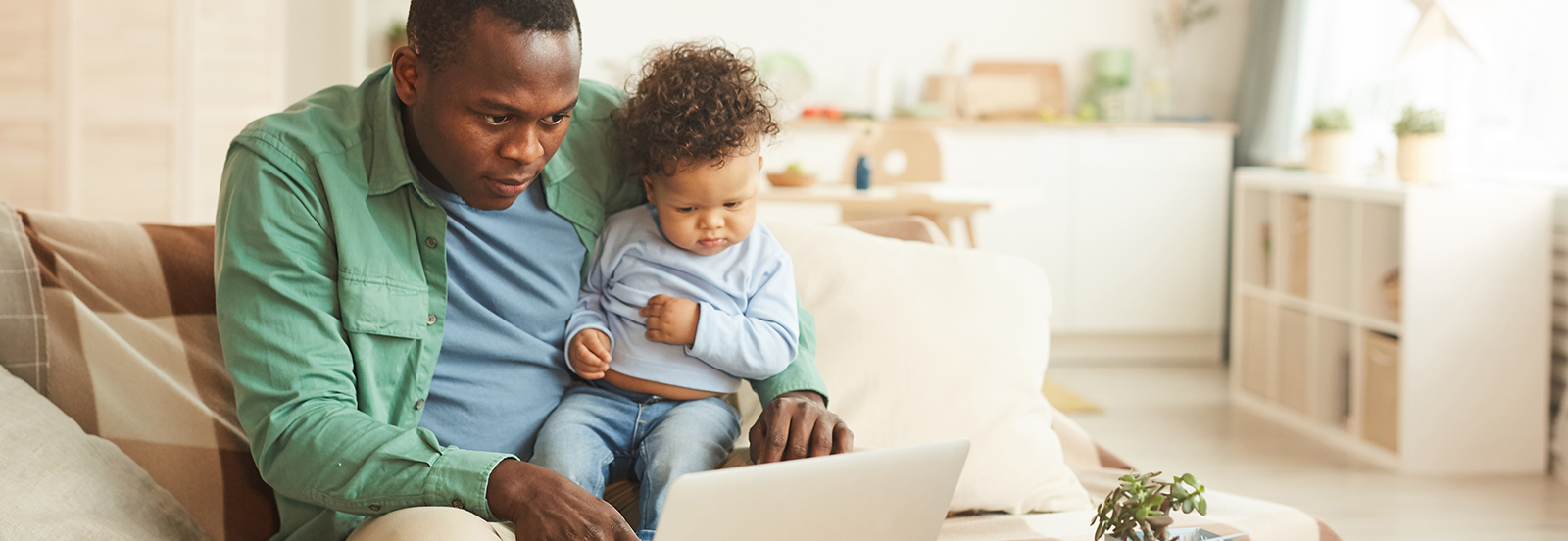 Father and child looking at laptop