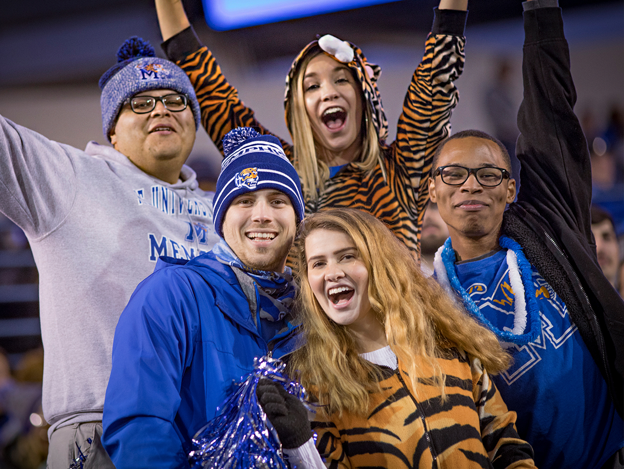 group of students cheering at football game