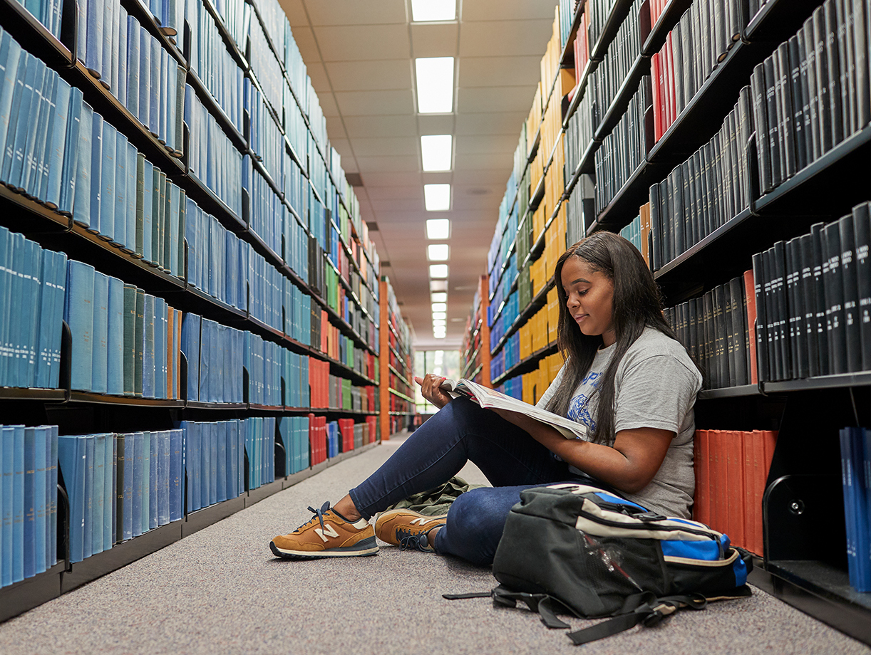 student studying in library