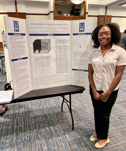 Marthea Vann-Scott presenting her poster at the UM Student Research Forum. Mentor: Dr. Deranda Lester Marthea Vann-Scott presenting her poster at the UM Student Research Forum. Mentor: Dr. Deranda Lester