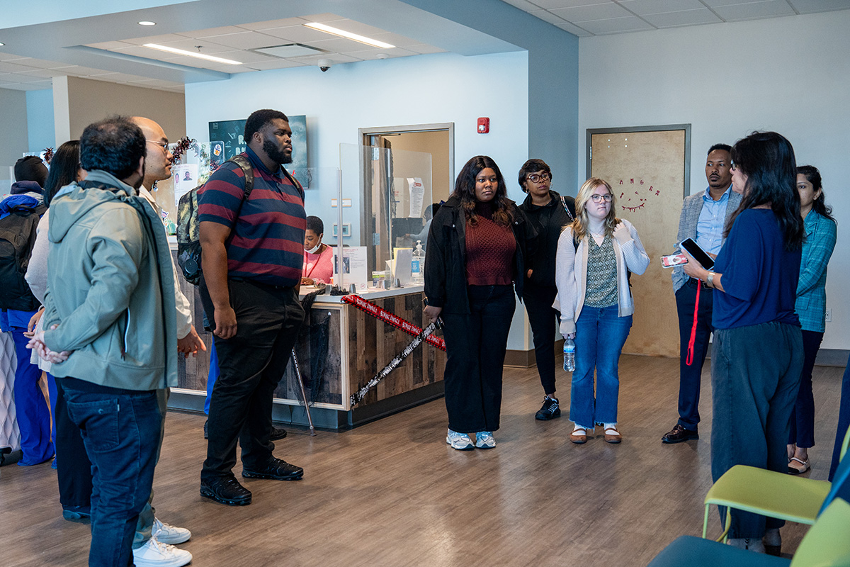 (Right) Su Hartline, Community Relations Manager at the Hospitality Hub, speaks to SPH students