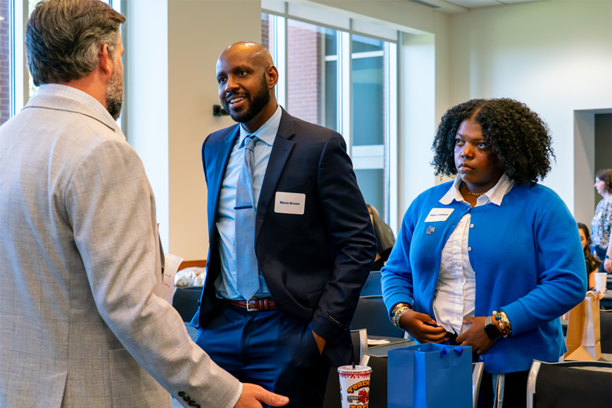 (L-R) Michael Drake speaks to MHA Students Mario Brown and Jalynn Caldwell