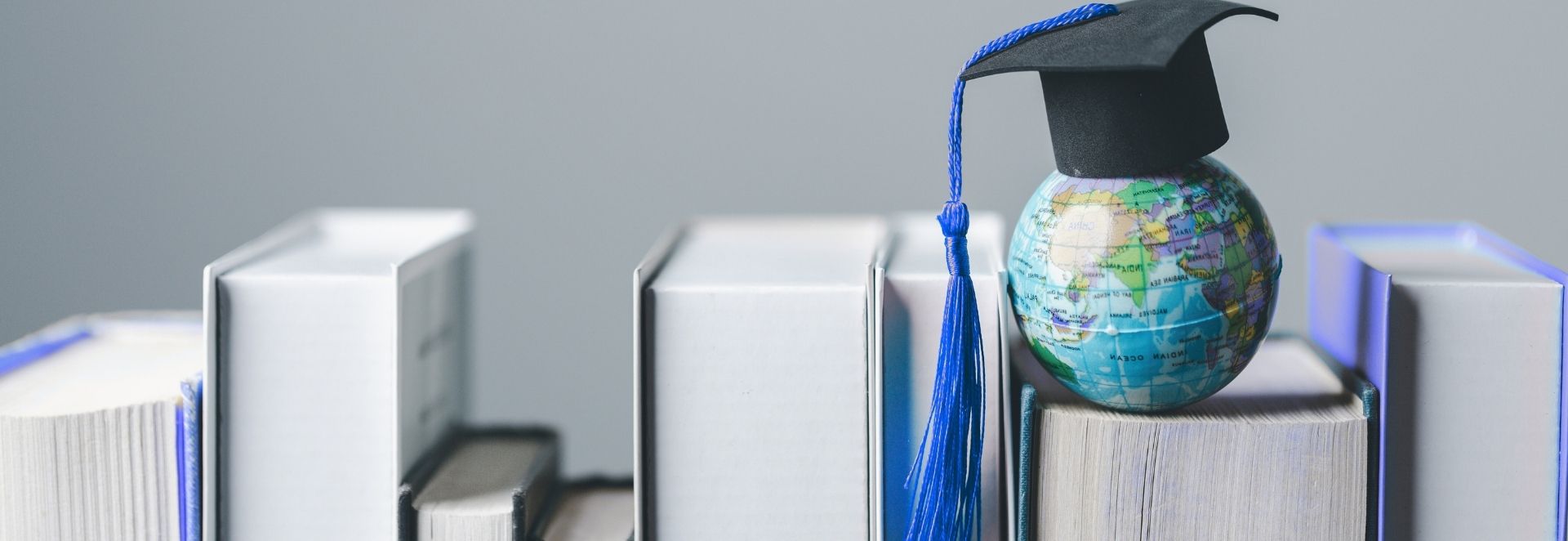 Header image having graduation cap, book and globe