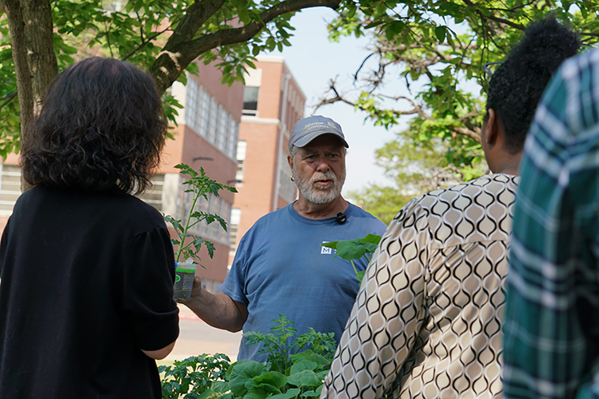 (Center) Art Johnson, TIGUrS Urban Garden Coordinator