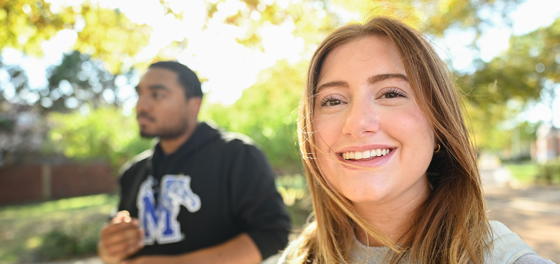 UofM students on campus smiling