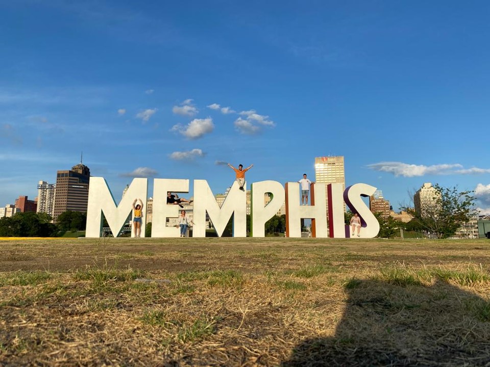 posing at Memphis sign downtown