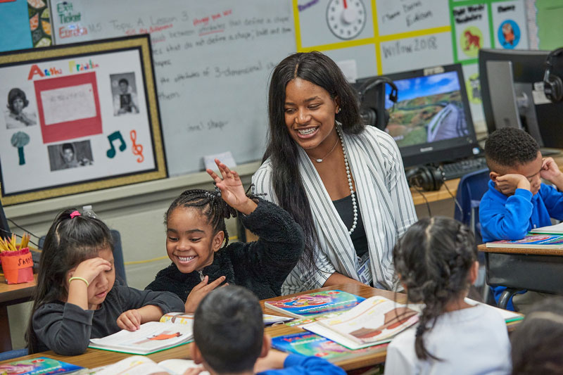 Student teacher working with elementary students