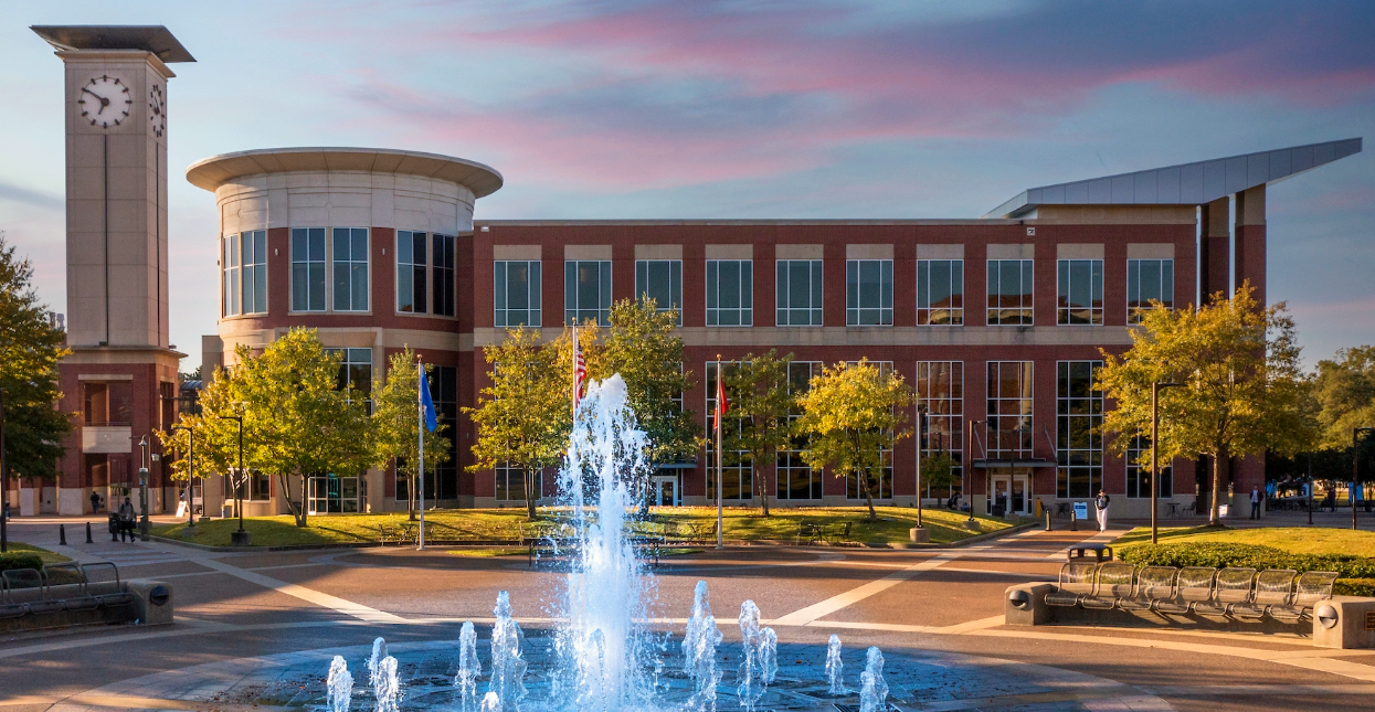 exterior photo of the UC building with fountain and clock tower
