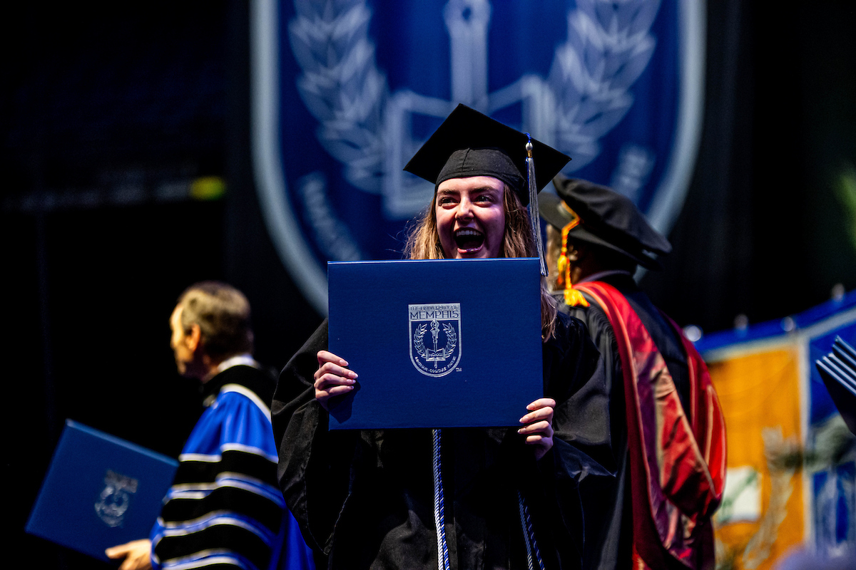 master grad apporaching president to shake hands.