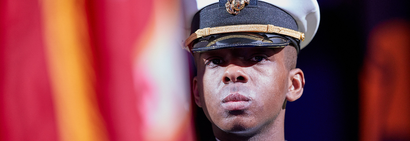 ROTC Color Guard Member at Commencement Ceremony with flag in background