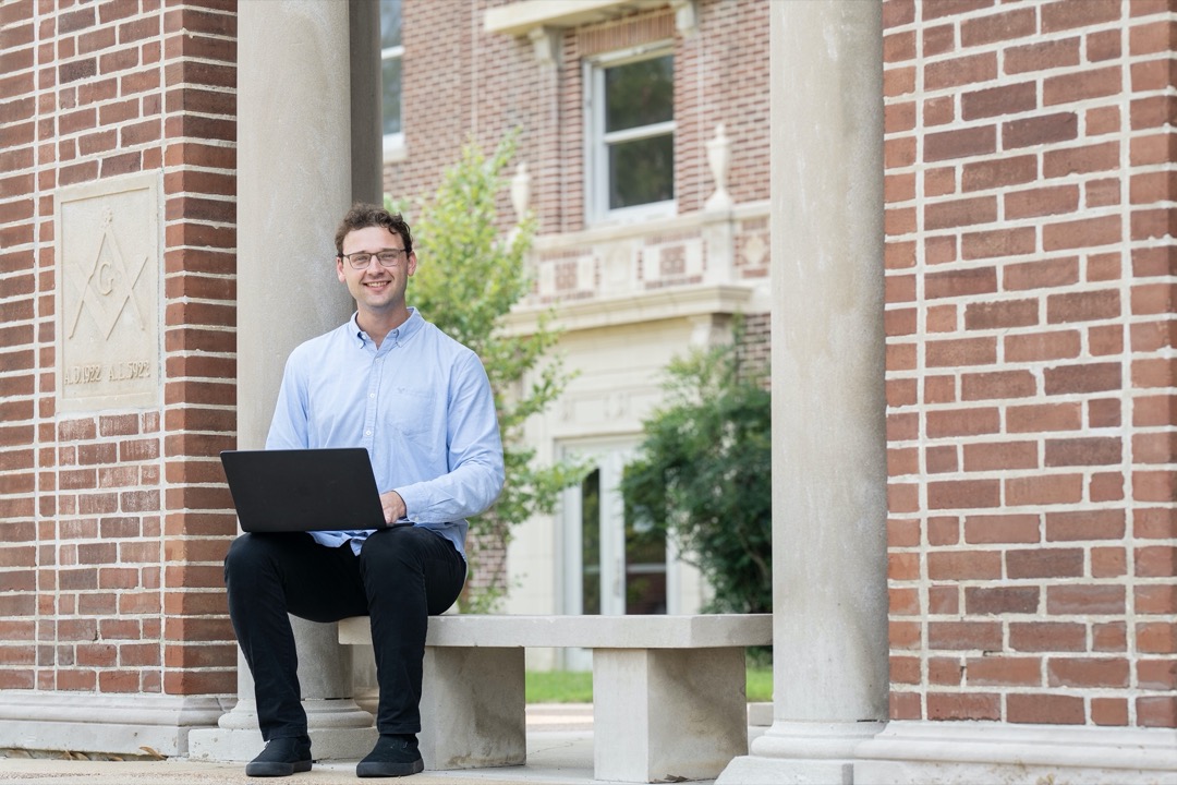 UofM Global Student on Campus with laptop