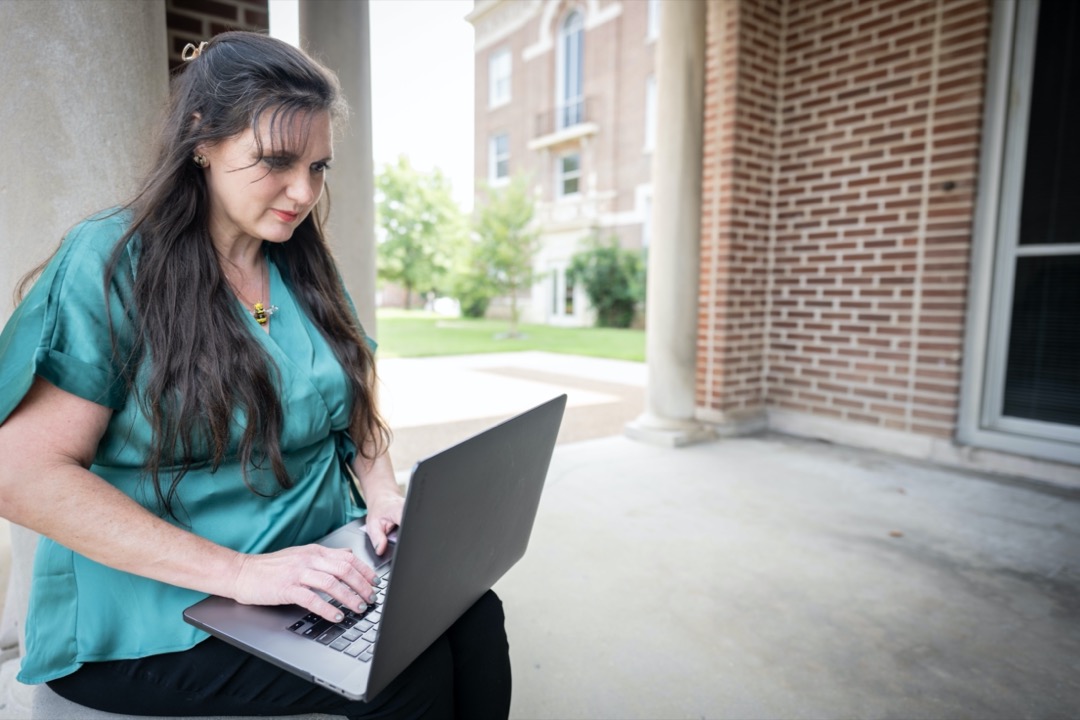 uofm global student on Campus with laptop