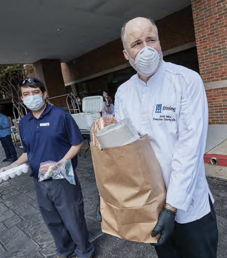 volunteers carry food packages 